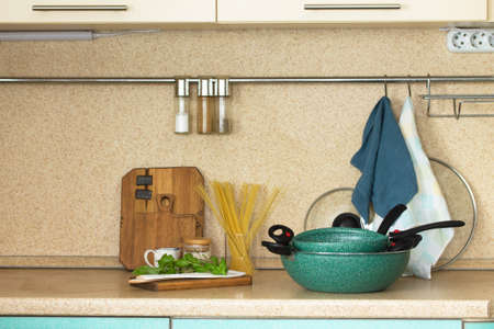 Cooking food background. Set of empty ceramic coated dishes on a stone countertop surrounded by...