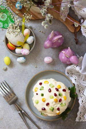 Holiday salad is not a sweet cake. Salad with rice, egg, crab sticks and cucumber on a stone or...