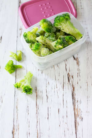 Healthy food is frozen. Containers with frozen broccoli. Copy space.の写真素材