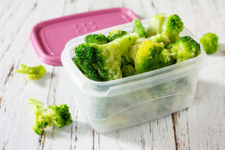 Healthy food is frozen. Containers with frozen broccoli.の写真素材