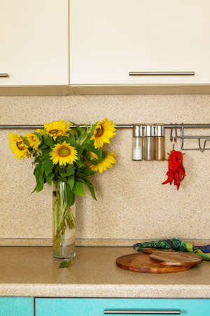 Kitchen interior and a bouquet of sunflowers on a stone countertop. Copy space.の写真素材