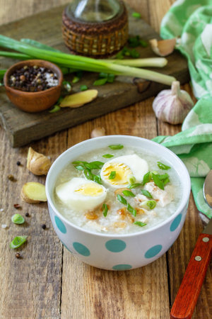 Hot soup chicken with ginger rice and garlic in a bowl on a rustic table. Copy space.の写真素材