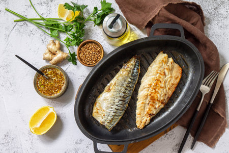 Grilled baked mackerel with ginger mustard honey sauce on a marble table top. Top view flat lay.の写真素材