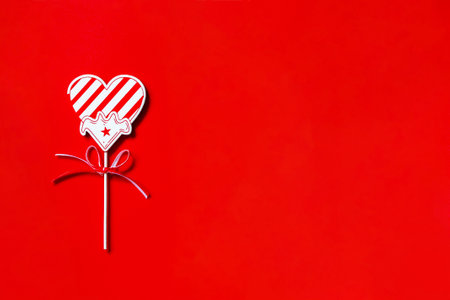 Wedding or Valentine's day concept. Red heart decor on red background. Top view, flat lay. Copy...