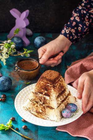 Easter background. Dessert tiramisu Easter cottage cheese pascha on festive table.