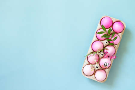 Minimal Easter concept. Festive spring mood, natural decor. Easter eggs in pink tones and gerbera...