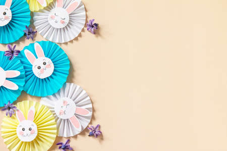 Children's paper decor. Funny paper easter bunny on sail Champagne trend background. Happy Easter greeting kids card. Top view flat lay. Copy space.の写真素材