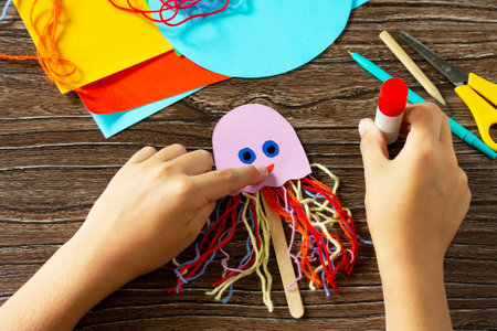 Instructions step 6. Summer puppet stics toy octopus. Handmade. Handmade. Childrens creativity project, crafts for kids.の写真素材