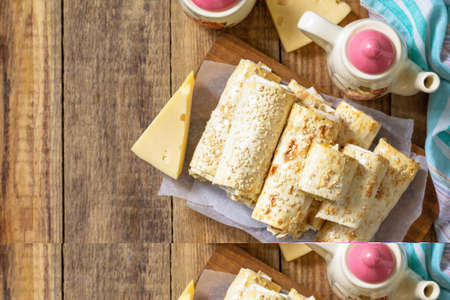 Breakfast, picnic, lunch or snack concept. Lavash roll with cottage cheese, cheese and spinach on a...