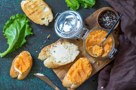 Sandwiches with butter and salted caviar on a dark stone countertop. Top view flat lay background.の写真素材