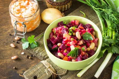 Beetroot salad vinaigrette with sauerkraut, pickled cucumber and vegetables on a wooden rustic table.の写真素材