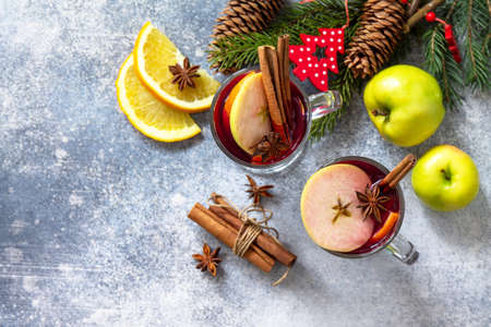 Christmas mulled wine, winter alcoholic drink. Two glass of mulled wine (gluhwein) and its ingredients on a stone background. Top view flat lay background. Copy space.の写真素材