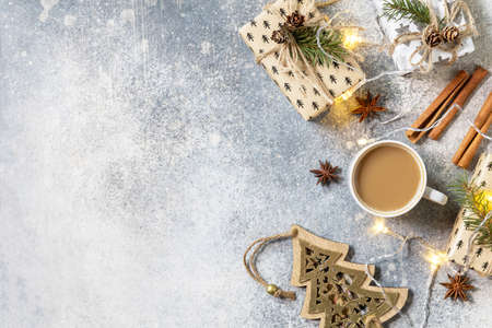Cup of coffee and xmas gifts on a gray stone tabletop. New year or christmas concept. Top view flat lay. Copy space.の写真素材