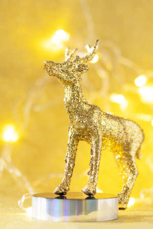 Magic of christmas. Christmas deer gold color palette with decor on a gold background for your greeting card.の写真素材