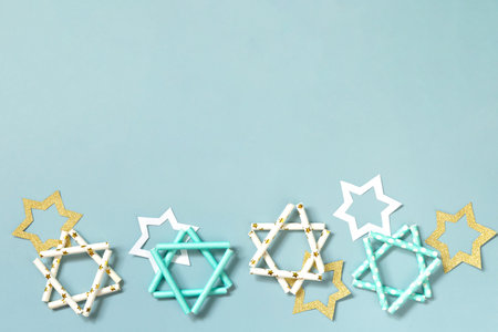 Jewish holiday Hanukkah. Symbol of Hanukkah star of David on a blue background. Top view flat lay....