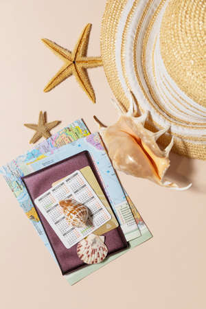 Minimal summer travel vacation concept. Passport with map, passport, starfish, glasses, bank card on...