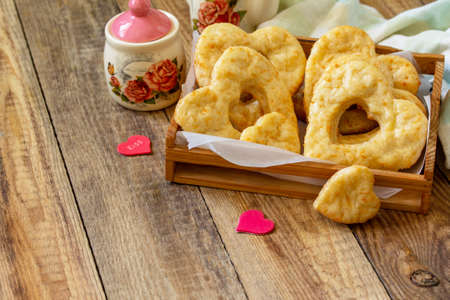 Valentine's Day, Birthday or Mother's Day, breakfast, holiday food. Homemade curd cheese cookies with hearts on a wooden rustic table. Copy space.の写真素材