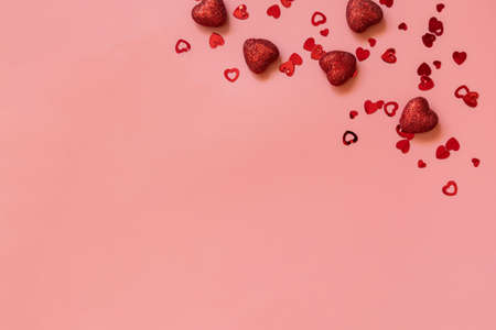 Valentines, love and wedding concept ideas. Frame red hearts on pink background. Flat lay, top view....