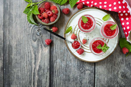 Healthy breakfast. Glass jars with chia pudding with raspberry and jam or smoothies with chia seeds...