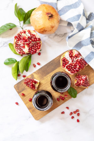 Healthy drink diet immunity vitamins or vegetarian food concept. Pomegranate juice in glass bottles and fresh pomegranate fruits. view from above.の写真素材
