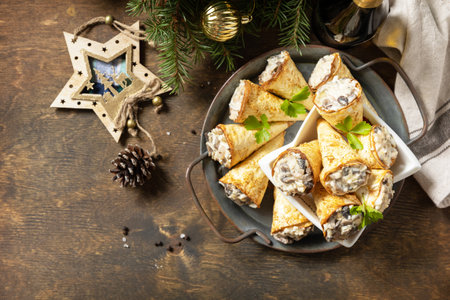 Creative appetizers christmas. Lavash roll cone with chicken and mushroom salad on a plate. Top view, flat lay. Copy space.の写真素材