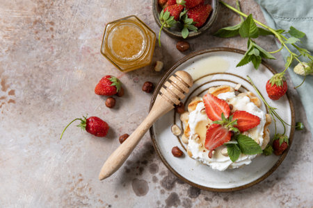 Belgian waffles with fresh berry strawberries and ricotta cheese for breakfast on a stone background. Sweet breakfast gluten free. Summer homemade recipe. View from above. Copy space.の写真素材