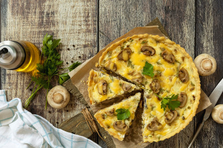 Delicious homemade mushroom quiche with mushrooms and green beans on rustic table. Top view flat lay background. Copy space.の写真素材