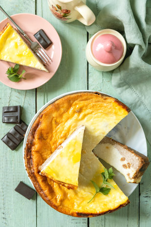 Delicious lemon cheesecake with tea set for dessert presentation. Top view flat lay background.の写真素材