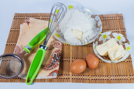 Ingredients for a batch of eggs, butter, and flour の写真素材