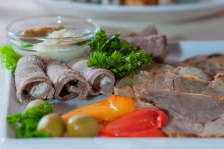 Appetizing cold cuts with olives and herbsの写真素材