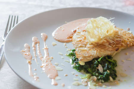 Fish dish with a slice of cheeseの写真素材