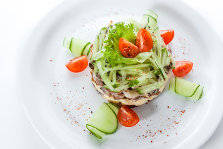 Dietary salad with cucumbers and tomatoes on a white backgroundの写真素材