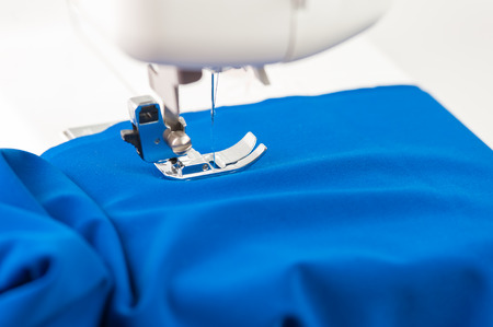 Sewing machine and tissue draped over a white backgroundの写真素材