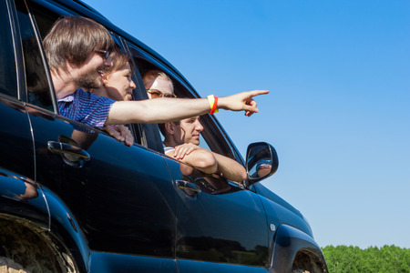 Outdoor portrait of young people looking out the window black carの写真素材