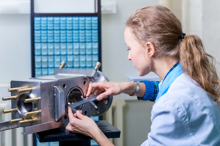 Woman mechanic with a caliper measuring deviceの写真素材