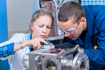 Man and woman mechanics measured the dimensions of the deviceの写真素材