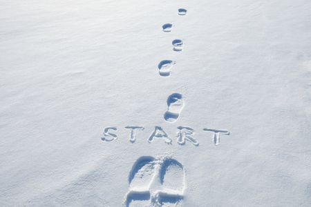 Concept picture.inscription start and footprints in the snowの写真素材