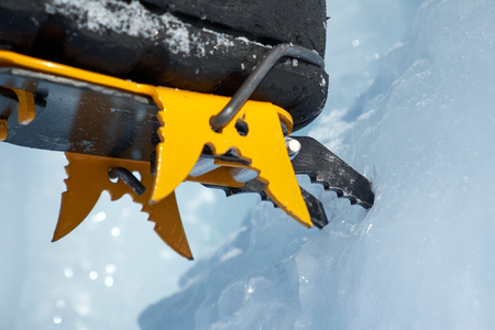 Crampons close-up on his feet ice climber, climber on a frozen waterfall