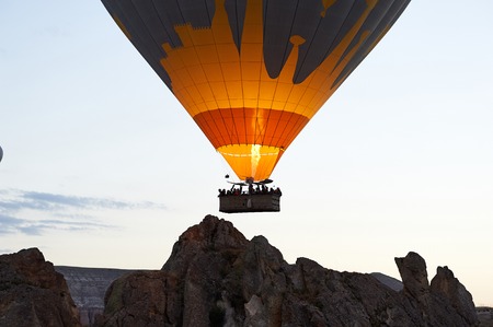 Hot Air Balloon Flight Cappadocia Tour Goreme Open Air Museum, Flying hot air balloons rise in sunrise Cappadocia. Goreme National Park Turkey.の写真素材