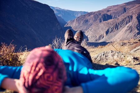 Hikers lie down taking resting after long walk at top of mountain.の写真素材