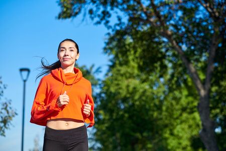 Running woman. Female Runner Jogging during Outdoor Workout in a Park. Beautiful fit Girl. Fitness model outdoors. Weight Loss.の写真素材