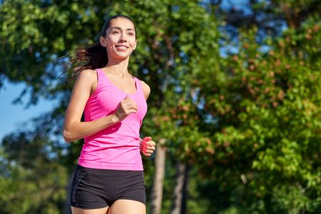 Running woman. Female Runner Jogging during Outdoor Workout in a Park. Beautiful fit Girl. Fitness...