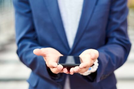 Business man hand with smart phone. render startup presentation. Background place for montage.の写真素材