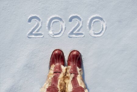Concept picture.inscription New Year 2020 and footprints in the snowの写真素材