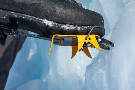 Crampons close-up on his feet ice climber, climber on a frozen waterfall