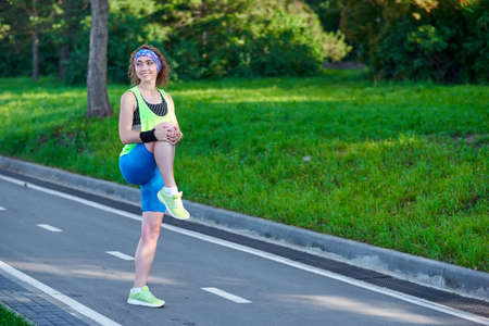 Fitness young woman stretching legs after run. outdoors after run