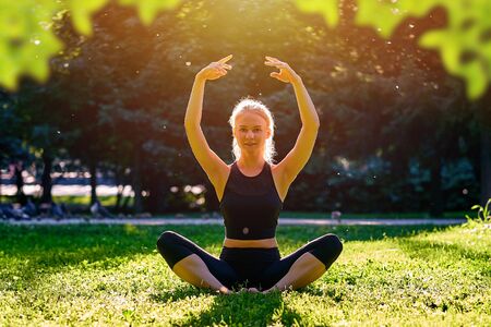 Yoga. Young woman practicing yoga or dancing or stretching in nature at park. Health lifestyle...