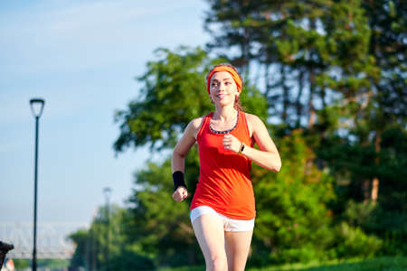 Running woman. Female Runner Jogging during Outdoor Workout in a Park. Beautiful fit Girl. Fitness...