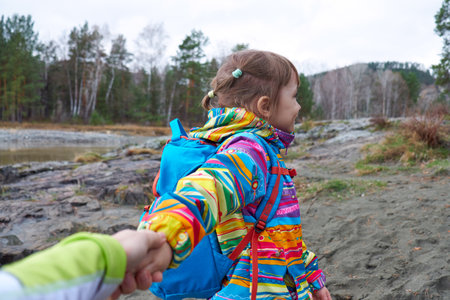 Follow me - Child daughter wanting her mother to follow her in travel or walk in wild natureの写真素材