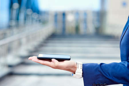 Business man hand with smart phone. render startup presentation. Background place for montage.